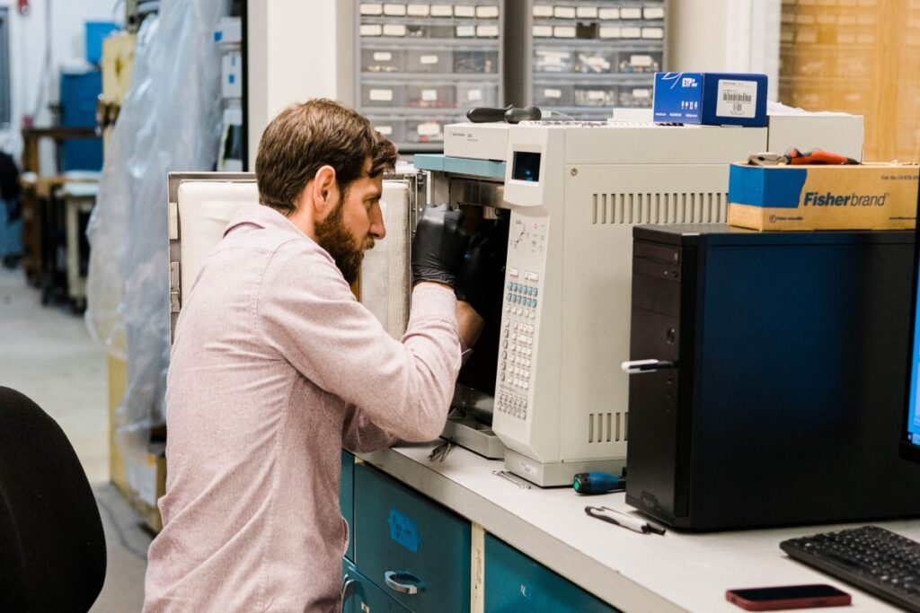 A technician refurbishing an HPLC machine.