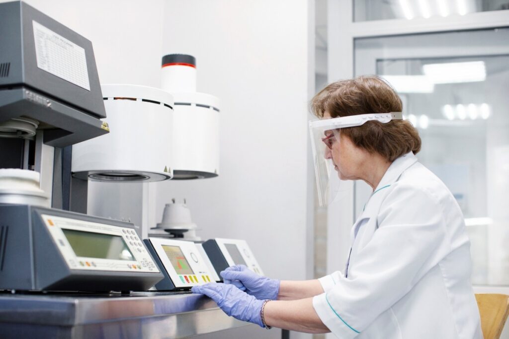 A lab technician working with equipment.